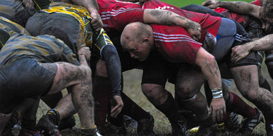 Rugby players in a muddy scrum